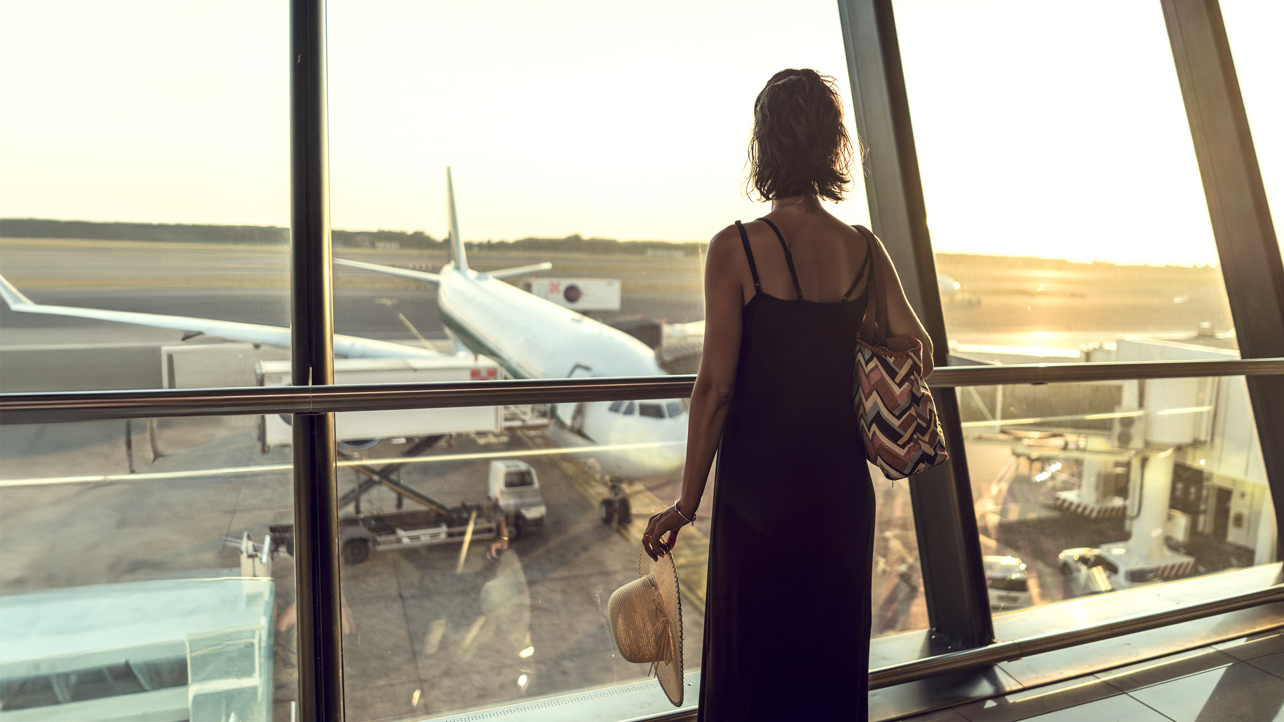 Kvinde i lufthavn kigger på fly