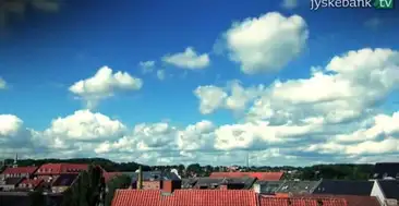 Hustage og himmel med skyer