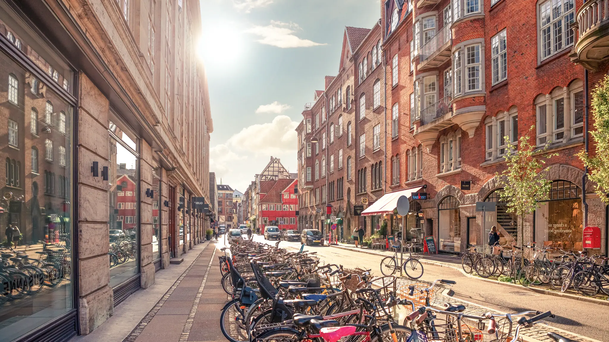 Bymiljø med cykler, butikker og lejligheder